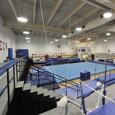 an empty gym with blue and white mats