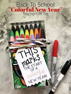 the back to school teacher's gift tag is in a box with crayons and marker pens