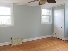 an empty room with hard wood floors and a ceiling fan