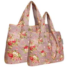 two bags with flowers on them sitting next to each other