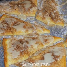 several pieces of pizza sitting on top of a pan covered in icing and powdered sugar