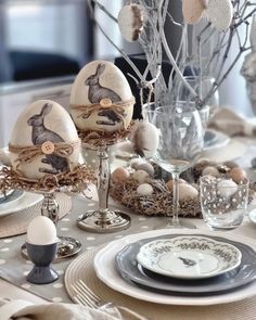 an easter table setting with eggs and other decorations