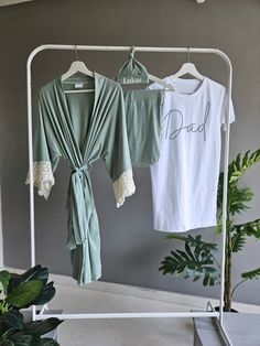 two shirts are hanging on a clothes rack