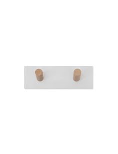 two small wooden buttons on a white surface