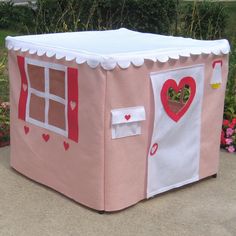 a pink play house with hearts on it