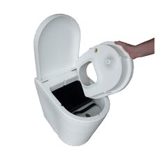 an open toilet with the lid up and someone's hand holding it out to flush