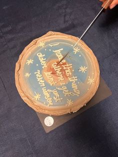 a cake that is sitting on top of a piece of paper with an arrow sticking out of it