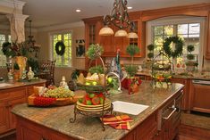 a kitchen filled with lots of counter top space next to a sink and stovetop oven