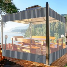 an outdoor gazebo with chairs and tables on the deck near the water's edge