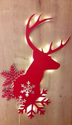 a red deer with snowflakes on it's antlers is lit up