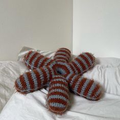 an orange and white striped teddy bear laying on top of a bed