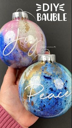 two ornaments with the words joy and peace painted on them