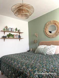 a bedroom with a bed, mirror and shelfs on the wall above it's headboard