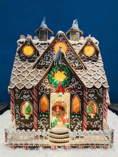 a gingerbread house is decorated with candy canes and icing on the roof