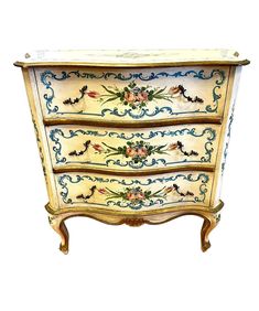 an ornately painted chest of drawers