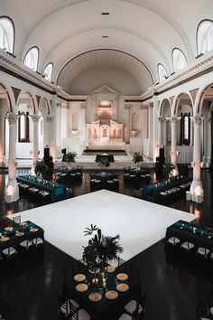 an empty banquet hall with tables and chairs set up for a formal function in the center