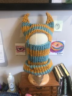 there is a knitted hat on top of a mannequin's head