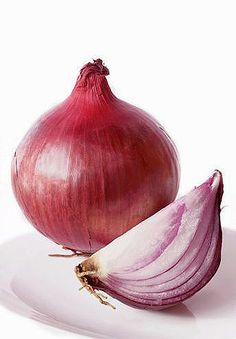 an onion is cut in half on a white plate