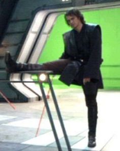 a man sitting on top of a metal chair