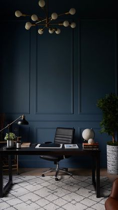 an office with dark blue walls and leather chairs, a black desk, potted plants and a lamp