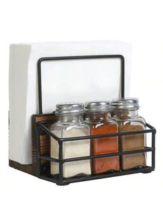 three spice jars in a metal holder