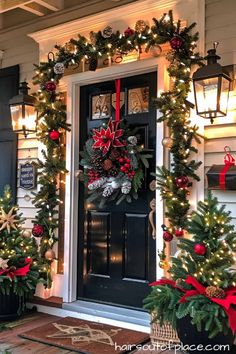 christmas wreaths on the front door of a house