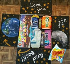 an assortment of snacks are displayed on the floor next to a sign that says i love you