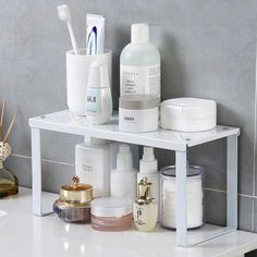 the bathroom shelf is organized with various items