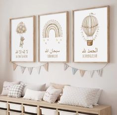 three framed pictures hang on the wall above a wooden bench with pillows and pillow cases