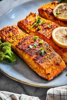 salmon and broccoli on a plate with lemons