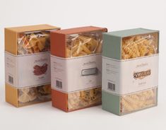 three boxes filled with pasta sitting next to each other