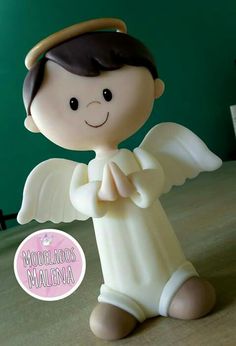 an angel figurine sitting on top of a table