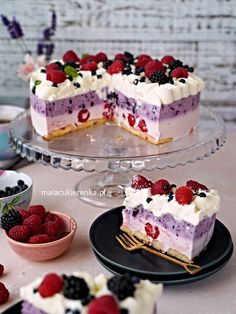 there is a piece of cake with berries on it and another slice has raspberries