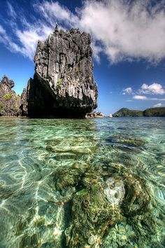 an island in the ocean with clear water