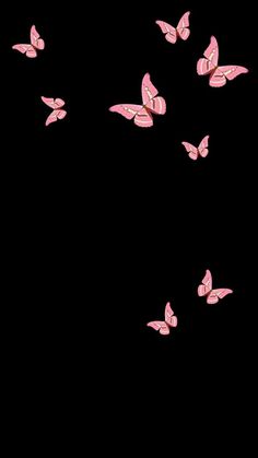 a group of pink butterflies flying through the air