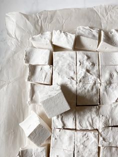 several pieces of white food sitting on top of a piece of paper