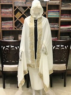 Complement your outfit with this Crepe Silk Summer Cape. This is very easy to style cape and it can be paired with any top, blouse, dress, or any other thing, no doubt you'll stand out from the crowd.Product Details- Condition Brand New - Style: Cape- Fabric: Crepe Silk - Fully lined from the back.- Embroidery: Zari Work - Colour: White- Size: 82" X 35" (208.28 cms X 88.9 cms) approx.- Care Instructions: Dry Clean Only.If you want a bigger or smaller size (dimensions), we can make it for you on White Pashmina Dupatta, White Embroidered Winter Kurta, White Resham Embroidery Shawl, Traditional Drape Abaya With Resham Embroidery, Traditional Long Sleeve Cape, Elegant Embroidered Cape-style Dupatta, Designer Cape Dupatta With Resham Embroidery, Ceremonial Cream Embroidered Dupatta, Elegant Embroidered Cape Dupatta