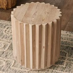 a wooden stool sitting on top of a rug