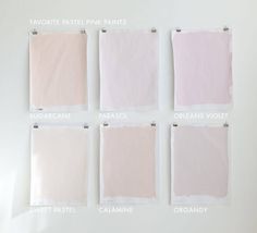 four different shades of pink and white paint are hanging on a wall with pins in them