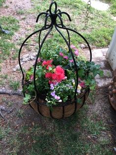 a planter with flowers in it sitting on the ground