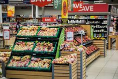 a grocery store filled with lots of fresh fruits and veggies for sale on shelves