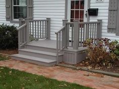 a house with white siding and gray steps