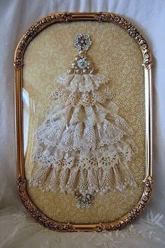 an ornate gold frame with a white lace christmas tree on the front and bottom part