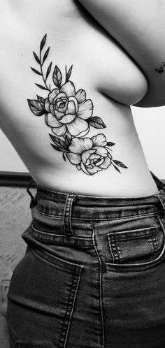 a woman's stomach with flowers on it and leaves in the bottom half - back