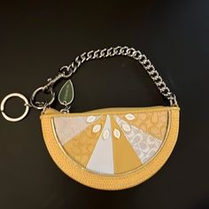 a purse with a chain hanging from it's side on a black surface,