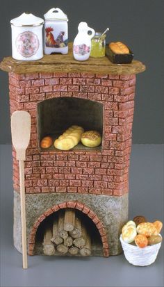 there is a brick oven with bread on the top and other food in bowls next to it