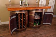 a wooden table with wine glasses and bottles on it