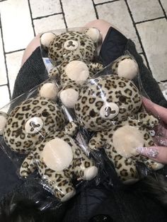 a person holding a bunch of stuffed animals in their hands with fake fur on them