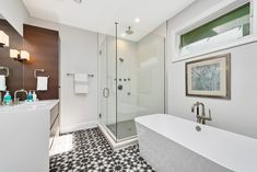 a white bath tub sitting next to a walk in shower