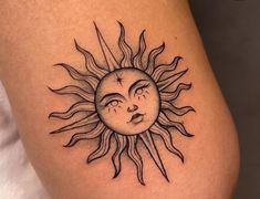 a sun with a sleeping face tattoo on it's leg and the moon behind it